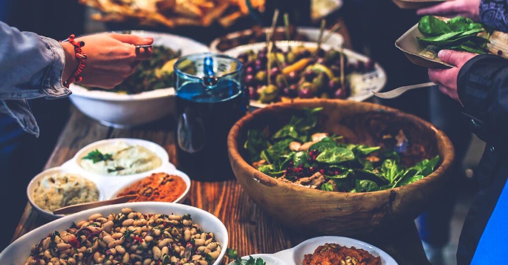 A vibrant buffet spread with salads, skewers, and dips at a lively indoor gathering.